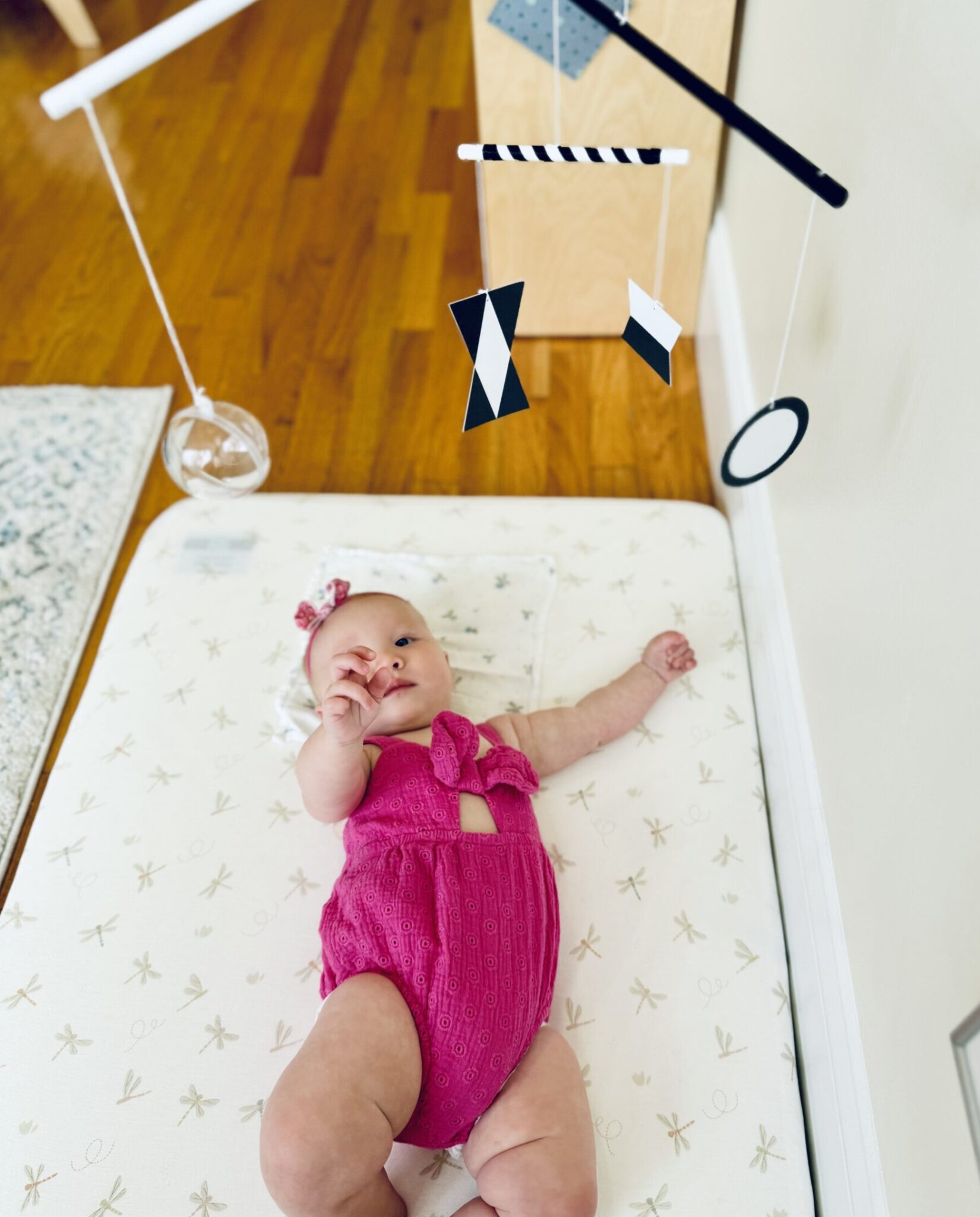 infant with montessori mobile infant with montessori mobile