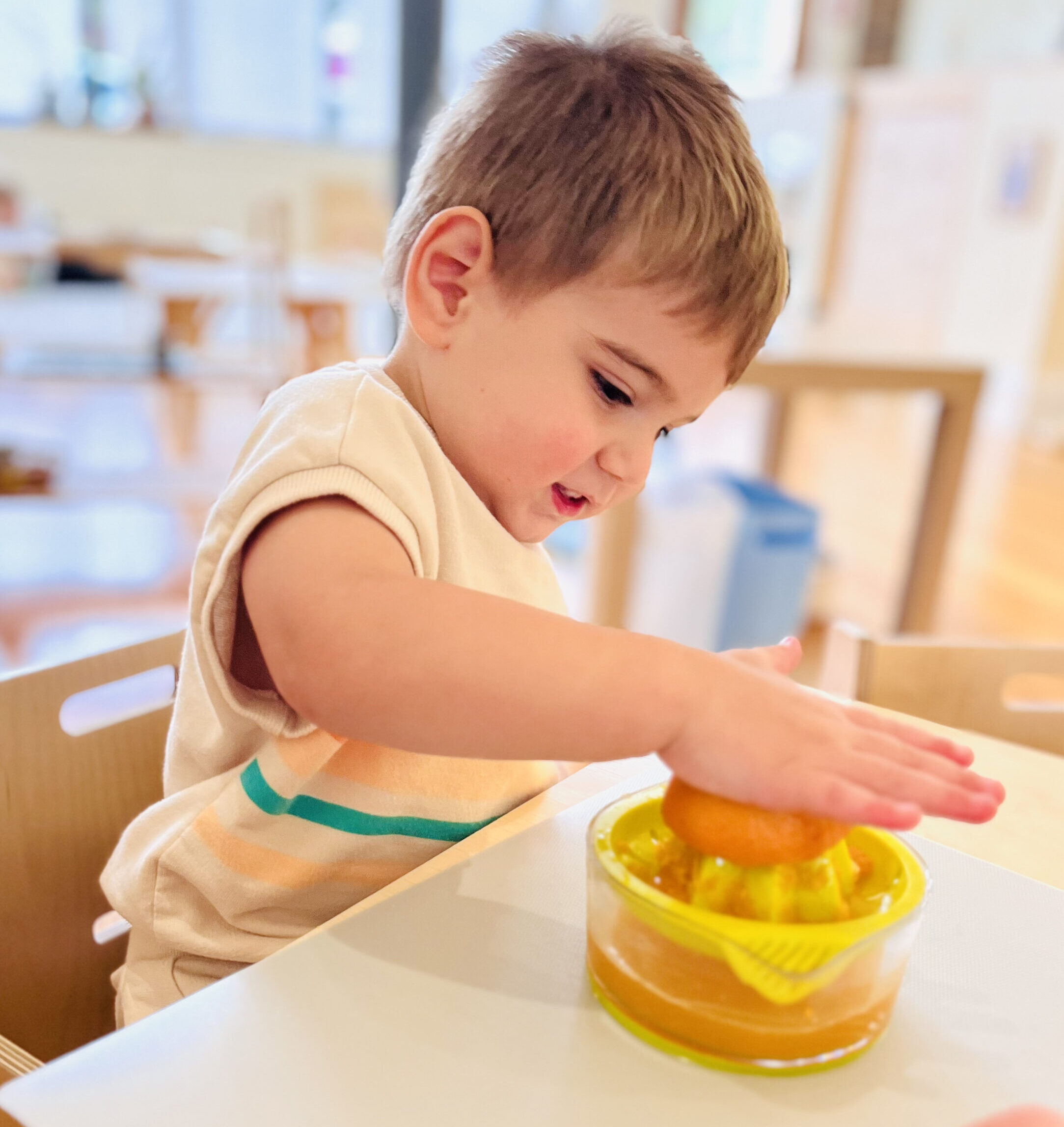 toddler squeezing orange juice toddler squeezing orange juice